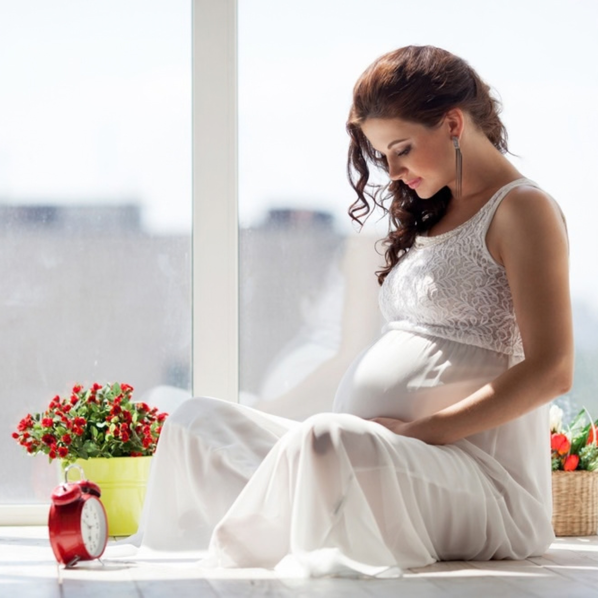 Pregnant woman resting her hands on her belly